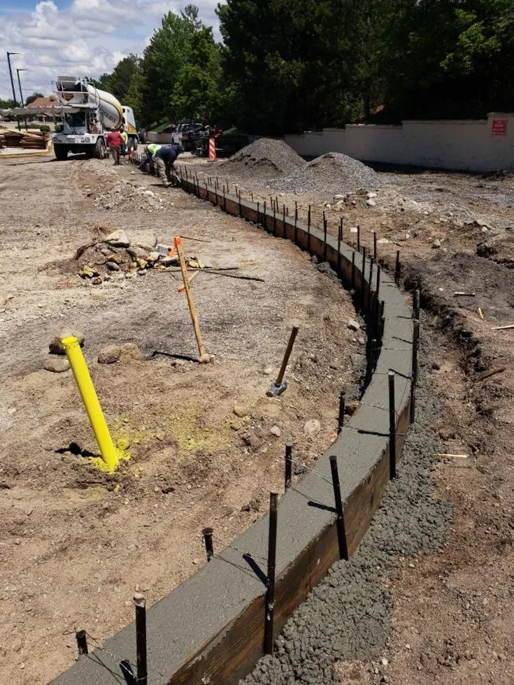 Curved concrete curb and footing installation with rebar