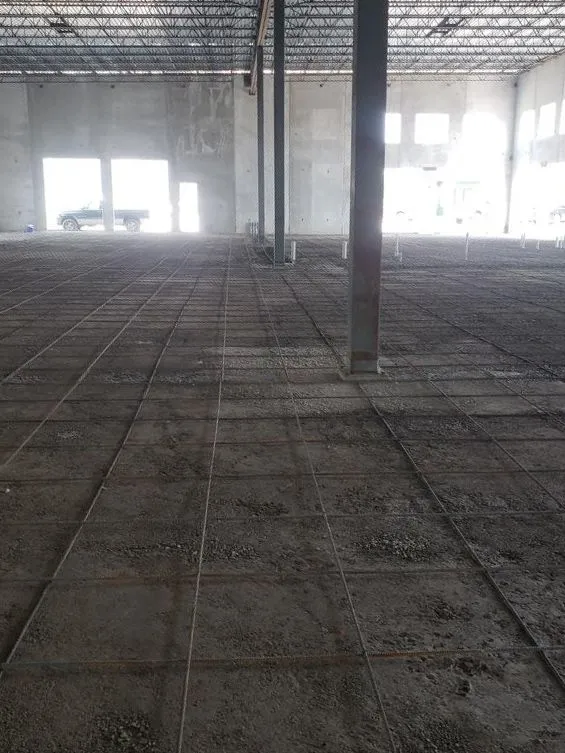 Large commercial concrete floor inside a building under construction