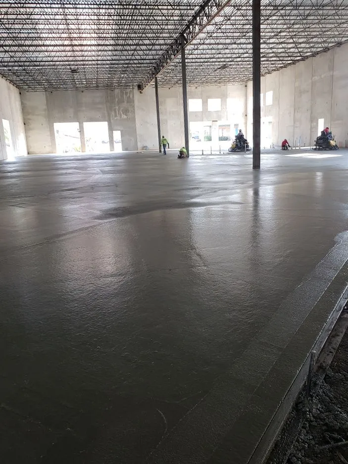 Large commercial warehouse concrete floor being finished