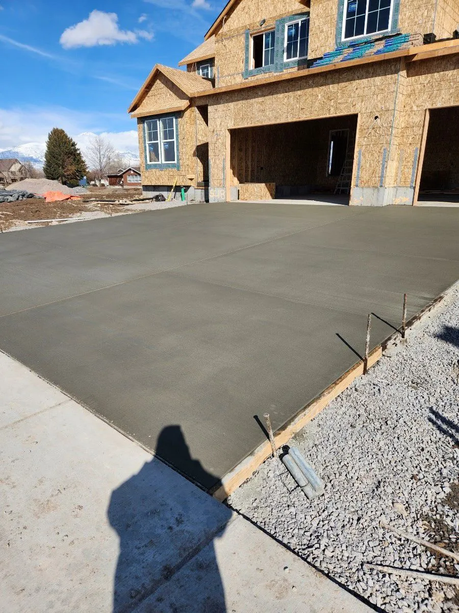 Freshly poured concrete driveway for a new home under construction